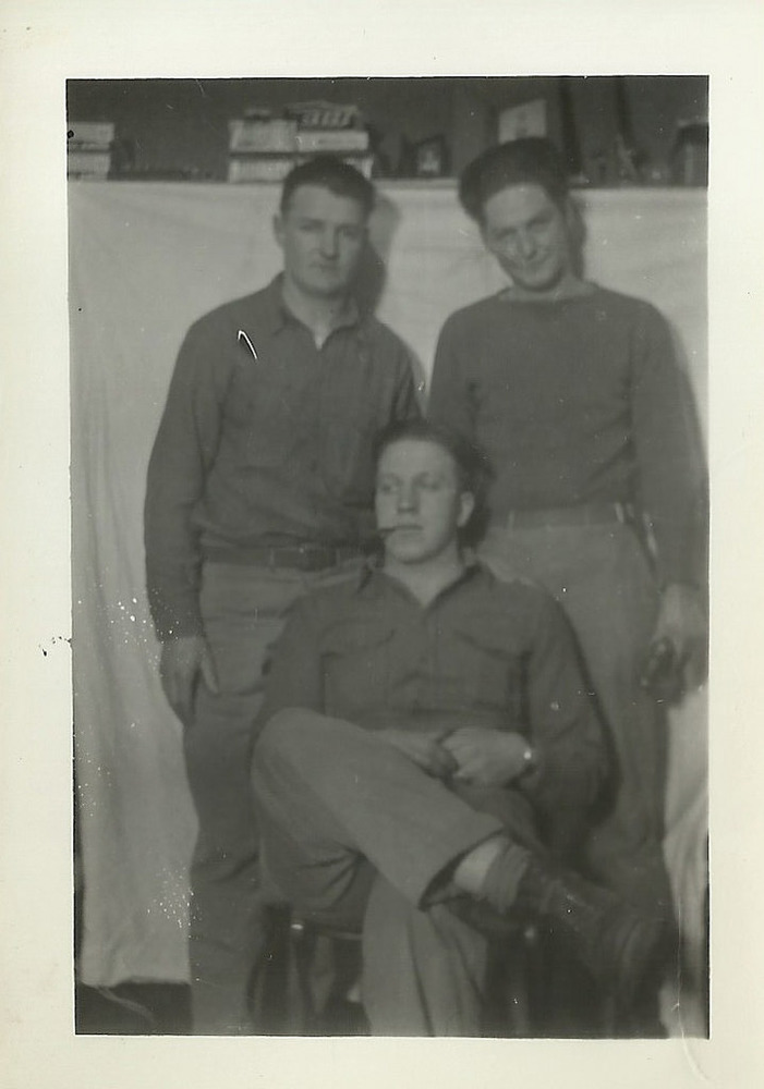 Three men pose for a picture