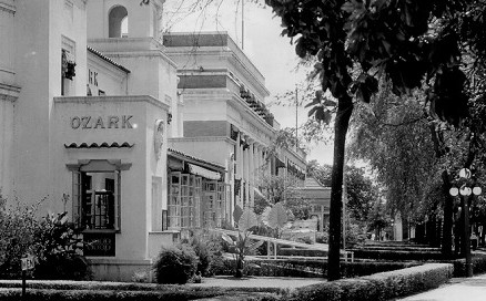 The word "Ozark" on the side of a white building announces the name of one of the bathhouses in the row.