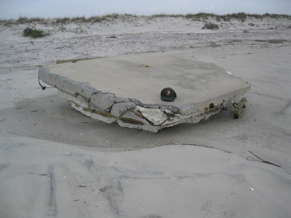 Section of floating dock marooned on ocean beach during Hurricane Irma.