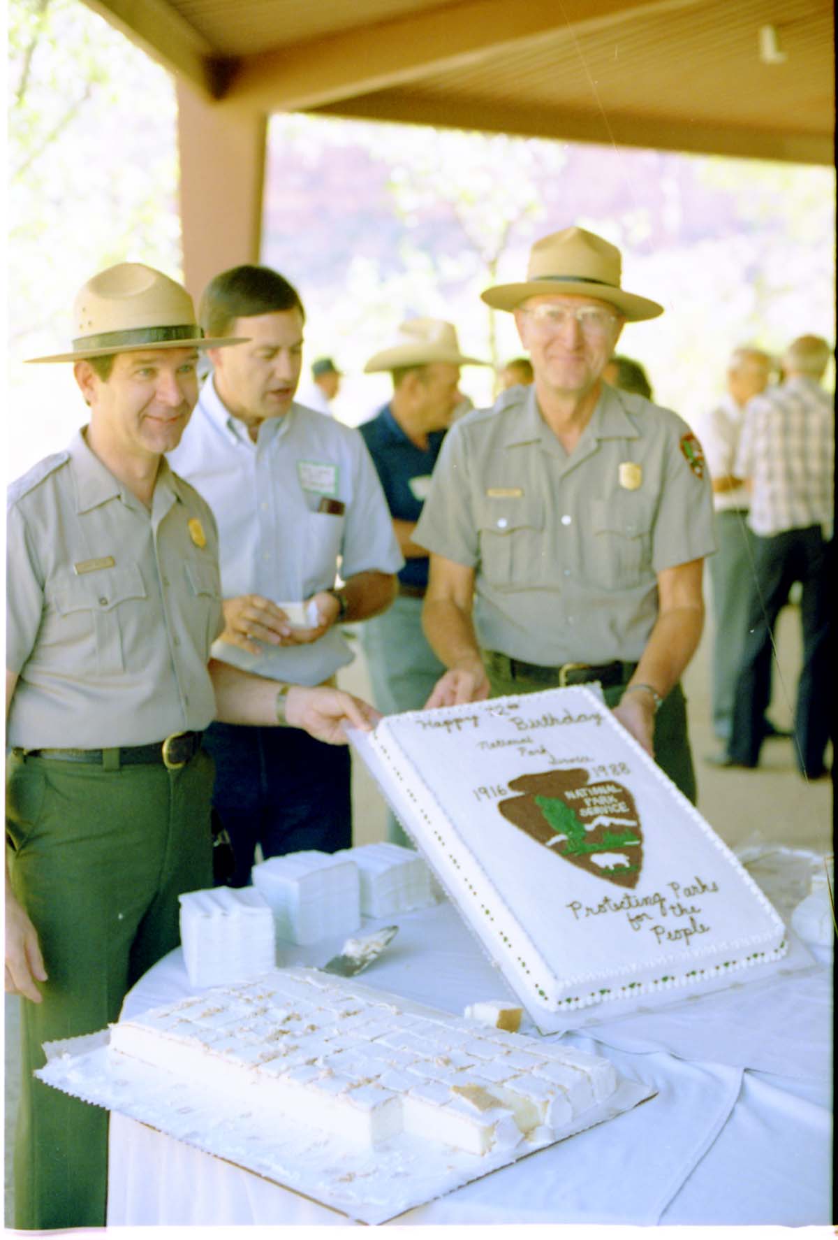 Color Photos of the parks 72nd anniversary celebrations- cake cutting, barbecue, speakers.