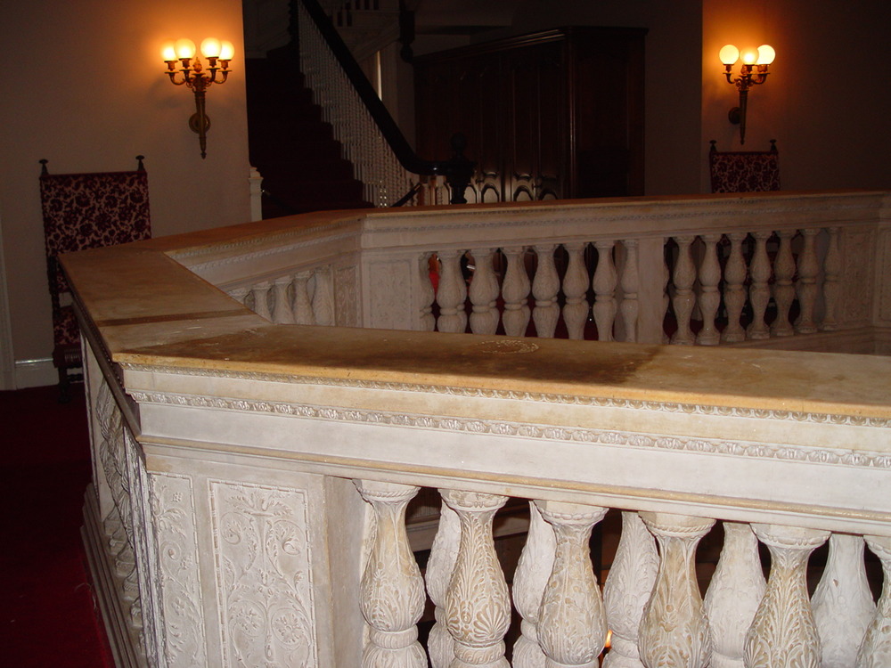 A large portion of the handrail is shown with sections that have been cleaned (the lighter areas) adjacent to uncleaned areas (the darker sections).