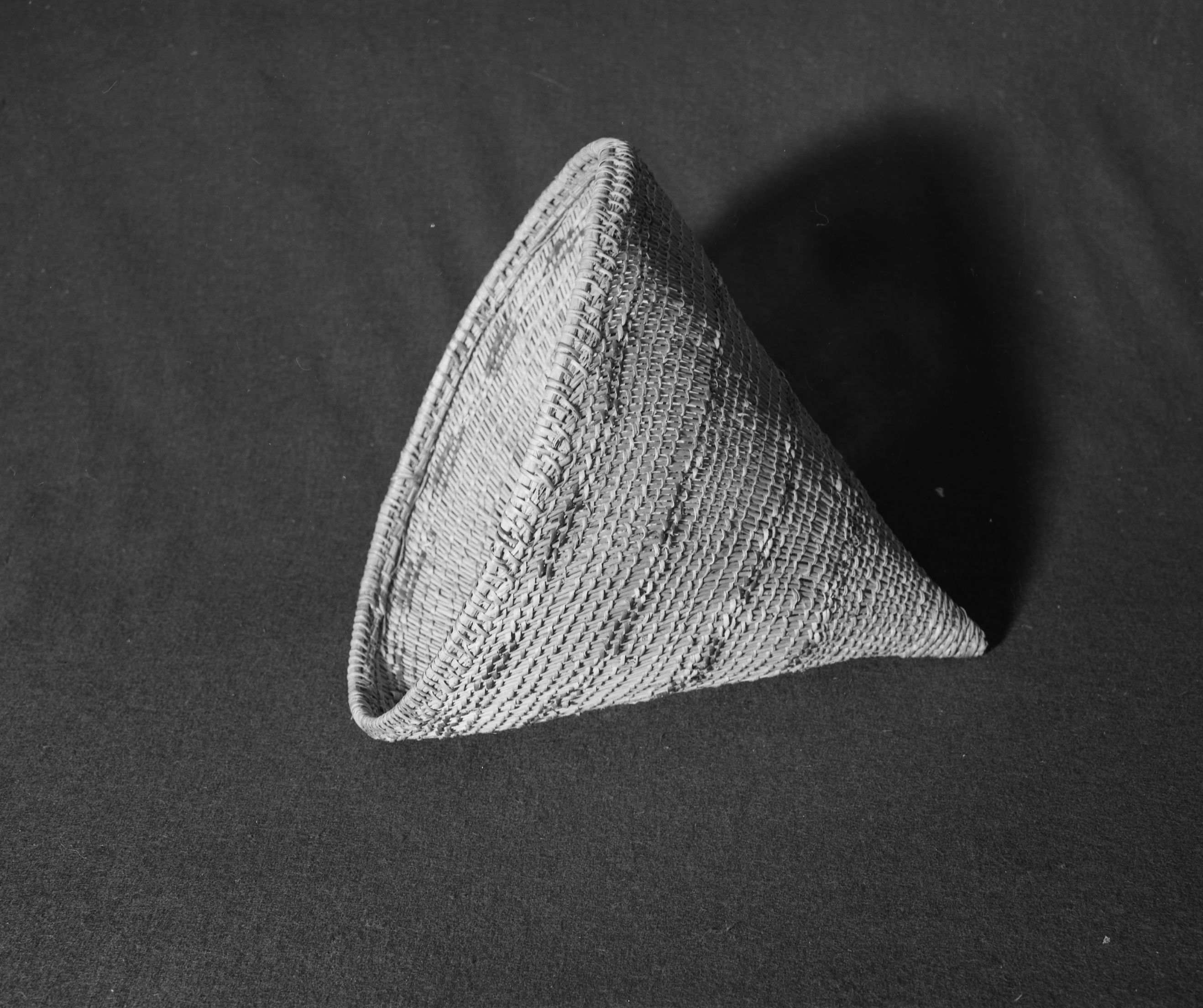 Marie Rozier Collection, Catalog No. 67. Object: Miwok burden basket. Dimensions: 13 x 14". Materials: redbud, chaparral sticks, split shoots. Technology: three strand twining at base in 7 spaced rows, body of basket in diagonal twining, up to right slant of turns. Collection History: Acquired from Mrs. Higgins, niece or daughter of Susie Smith, probably pre-1920. Photographed by Michael Dixon in December 1982. Catalogued by Craig Bates and Barbara Beroza. Yosemite Collections, National Park Service.