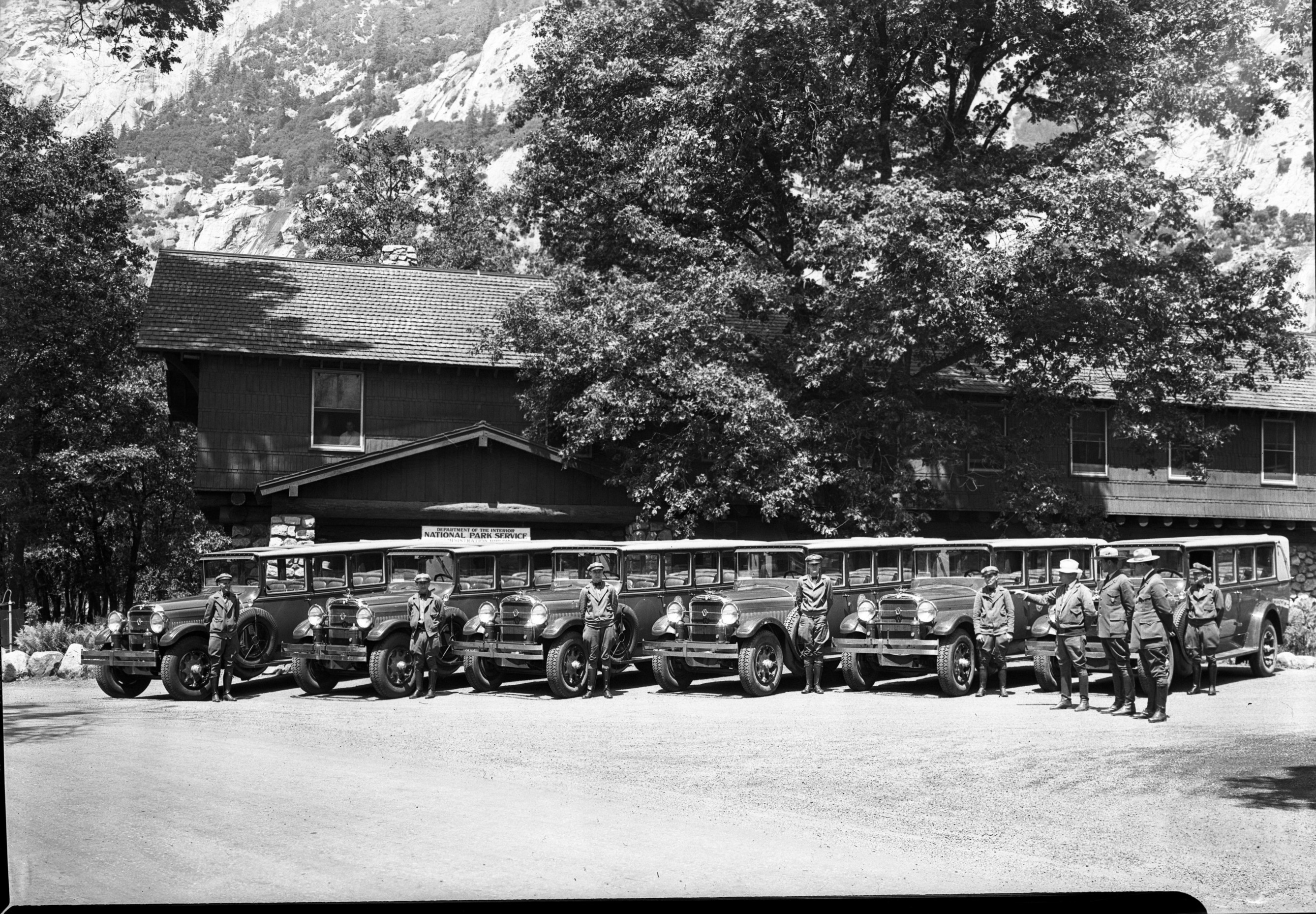 Copy Neg: Leroy Radanovich, December 2001. Auto stages with drivers in front of the NPS Administration Building.