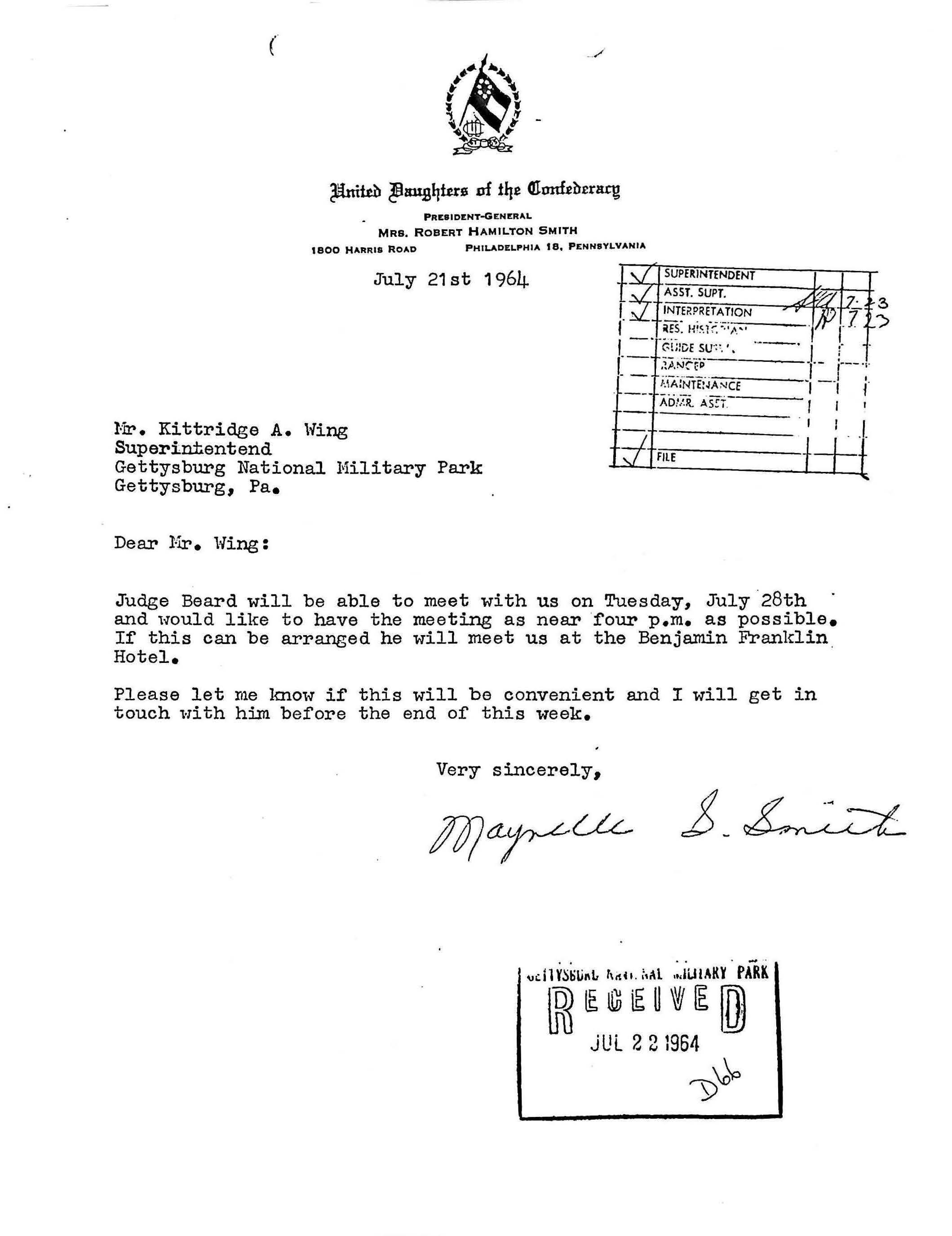 White paper with typed black text and a handwritten signature