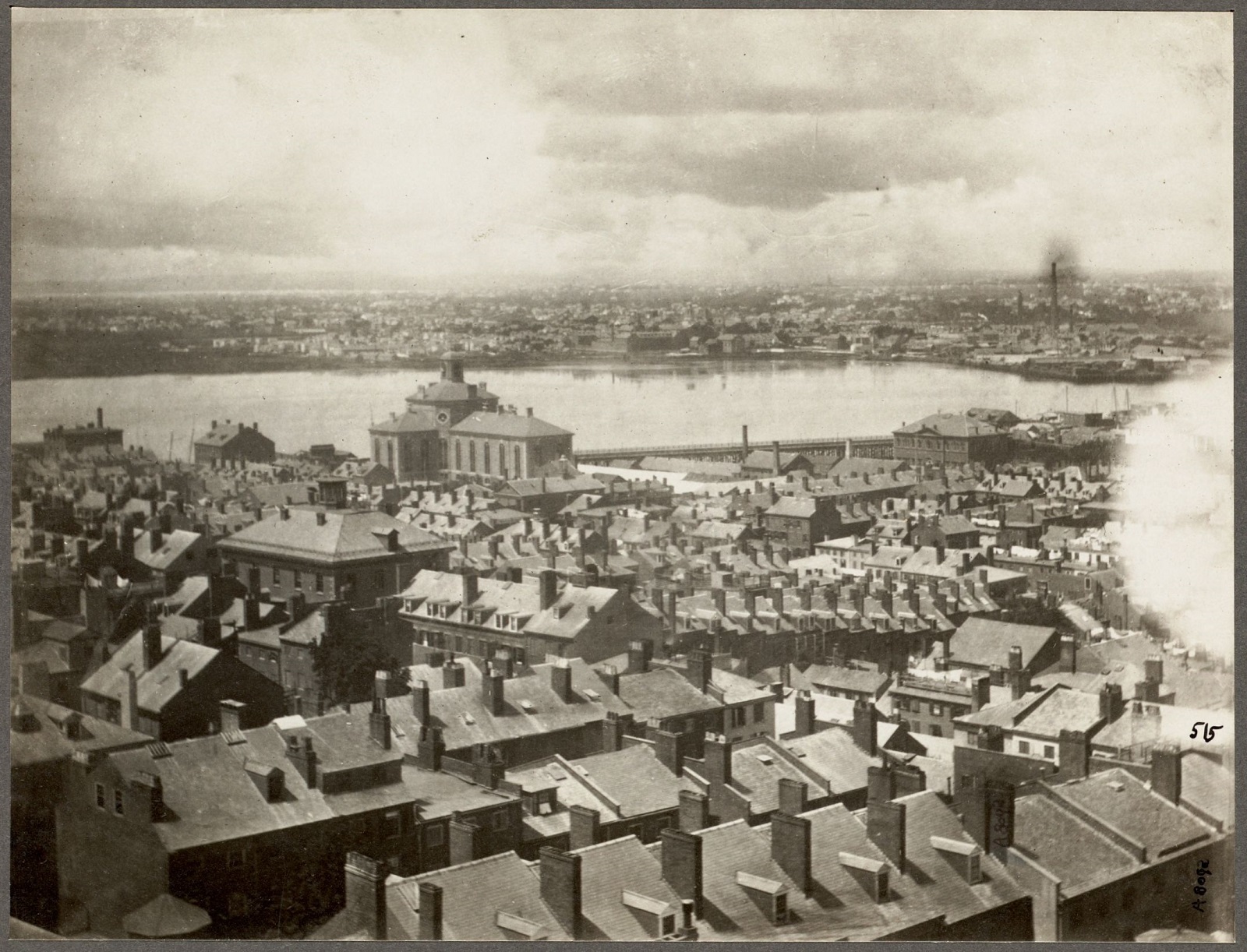 Aerial view looking onto the north slope of Beacon Hill with the Charles River and Cambridge in the background.