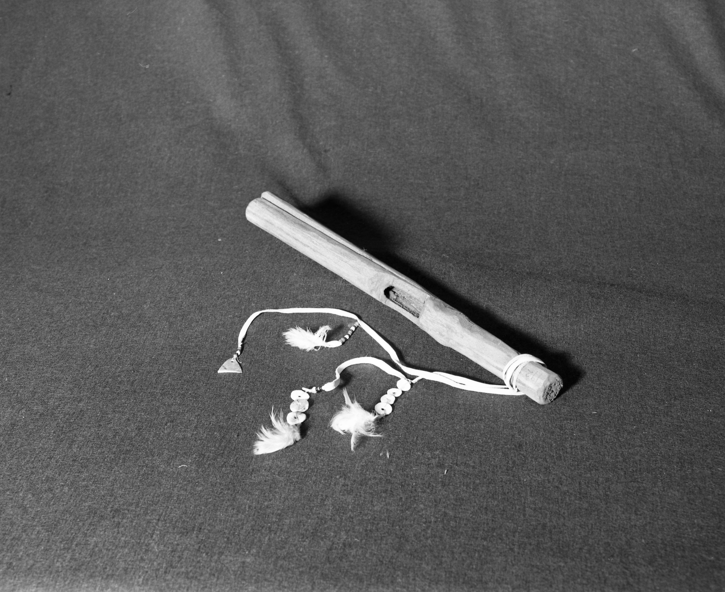 Marie Rozier Collection, Catalog No. 192. Object: Patwin clapstick rattle. Dimensions: 16 1/2". Materials: elderberry, buckskin, glass beads, barn owl fluff, abalone shell. Technology: ---. Collection History: Made by Craig Bates and Henry Azibill, 1969. Photographed by Michael Dixon, Dec. 1982. Catalogued by Craig Bates and Barbara Beroza. Yosemite Collections, National Park Service.