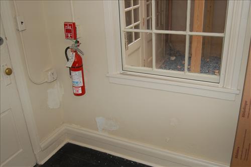 Water infiltration and damage to walls and floor of the Petersen House