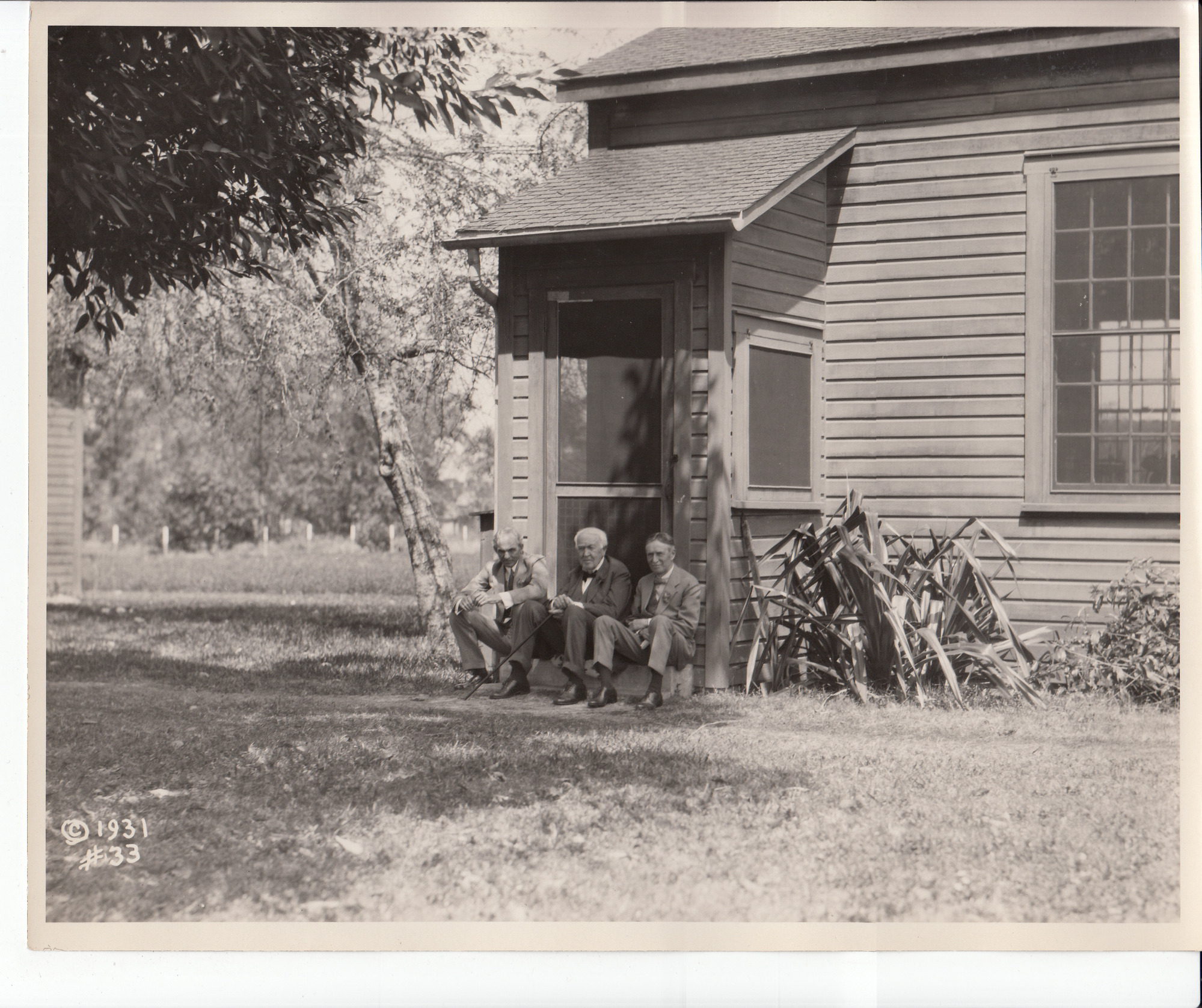 Henry Ford, Thomas Edison, and Harvey Firestone sitting on the stoop of the Fort Myers lab.