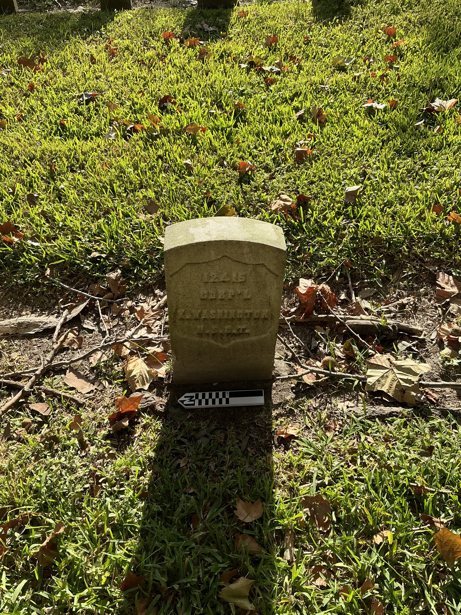 Extra image of historic upright marble headstone with recessed shield face.
