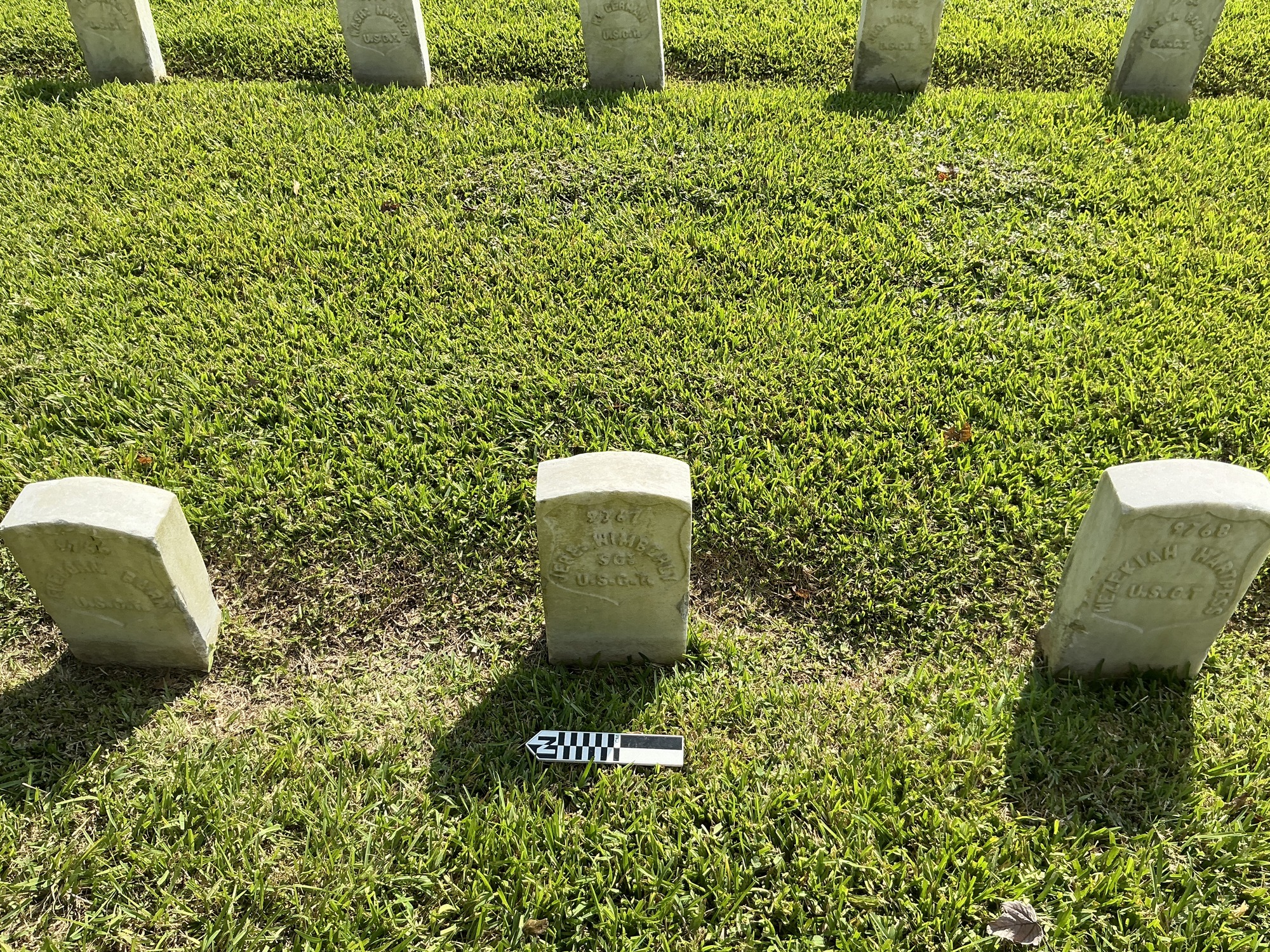Extra image of historic upright marble headstone with recessed shield face.