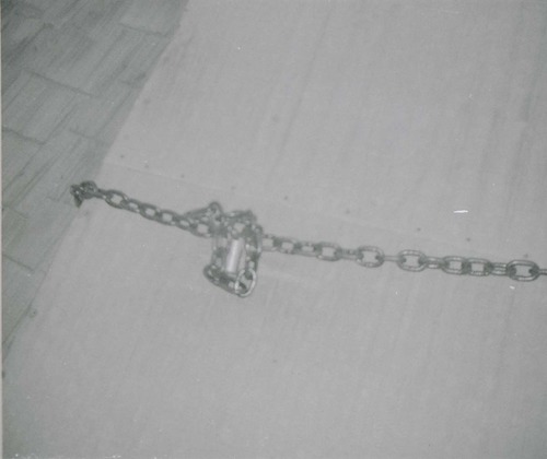 Chain and lock on hatch of water tank roof, prior to reroofing project.