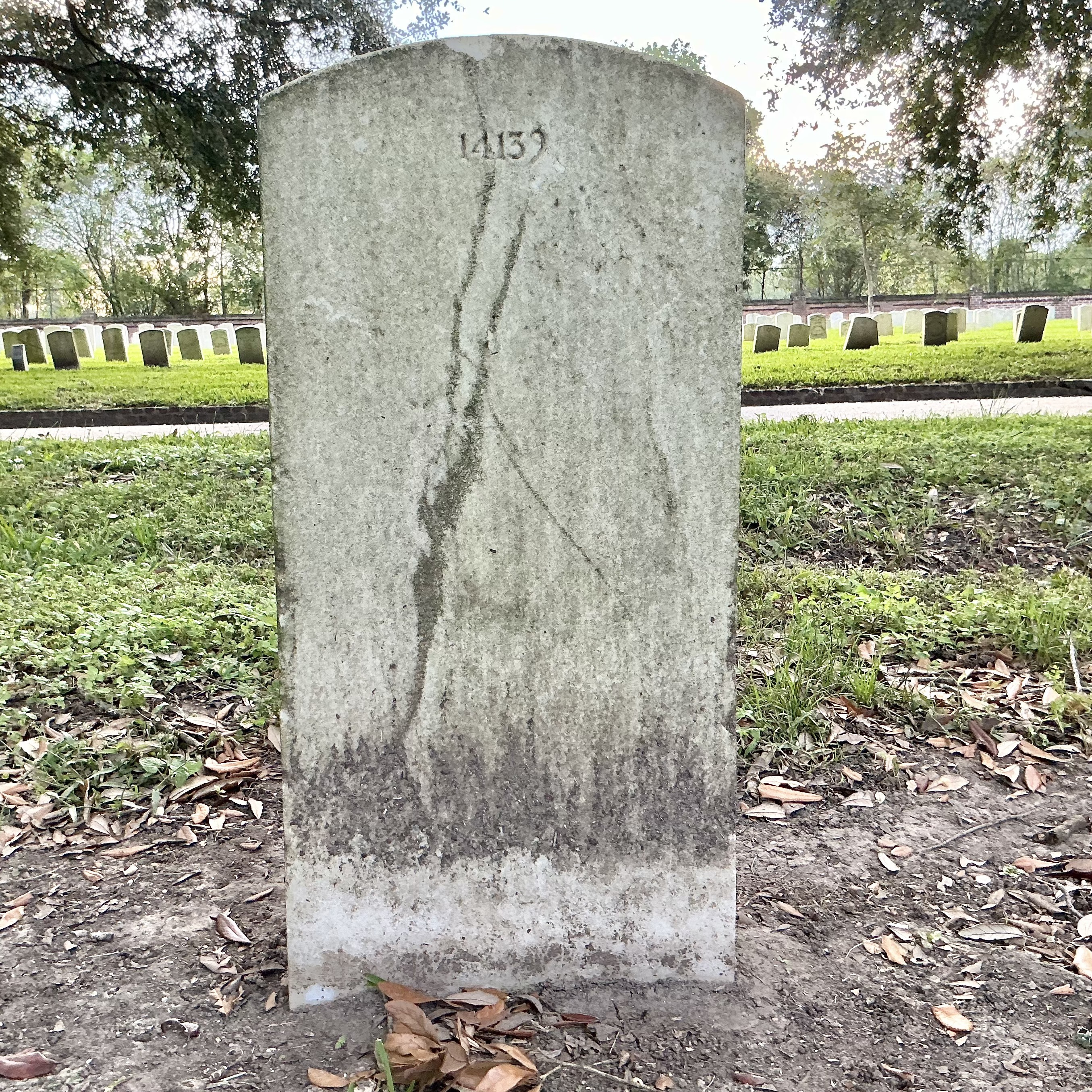 Back of upright marble headstone with flat face.