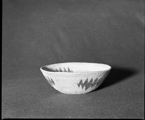 Marie Rozier Collection, Catalog No. 78. Object: Washoe or Paiute basket. Dimensions: 9-3/4 diameter x 3 1/4" height. Materials: Split willow, redbud, singe rod willow. Technology: Interlocking stitch, leftward coil direction, moving ends clipped on interior, fag ends concealed. Collection History: Bought at Woodfords new, ca. 1950s. Photographed by Michael Dixon, December 1982. Catalogued by Craig Bates and Barbara Beroza. Yosemite Collections, National Park Service.