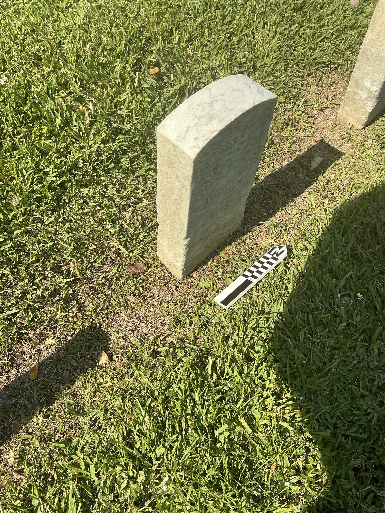 Extra image of historic upright marble headstone with recessed shield face.