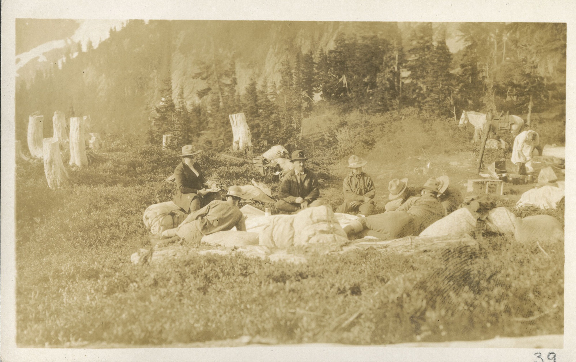 The Rinehart party resting in meadow at the outlet of Doubtful Lake.