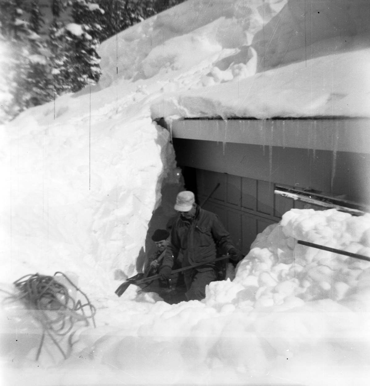 BW Photos showing rangers digging out the visitor center from snowdrift.