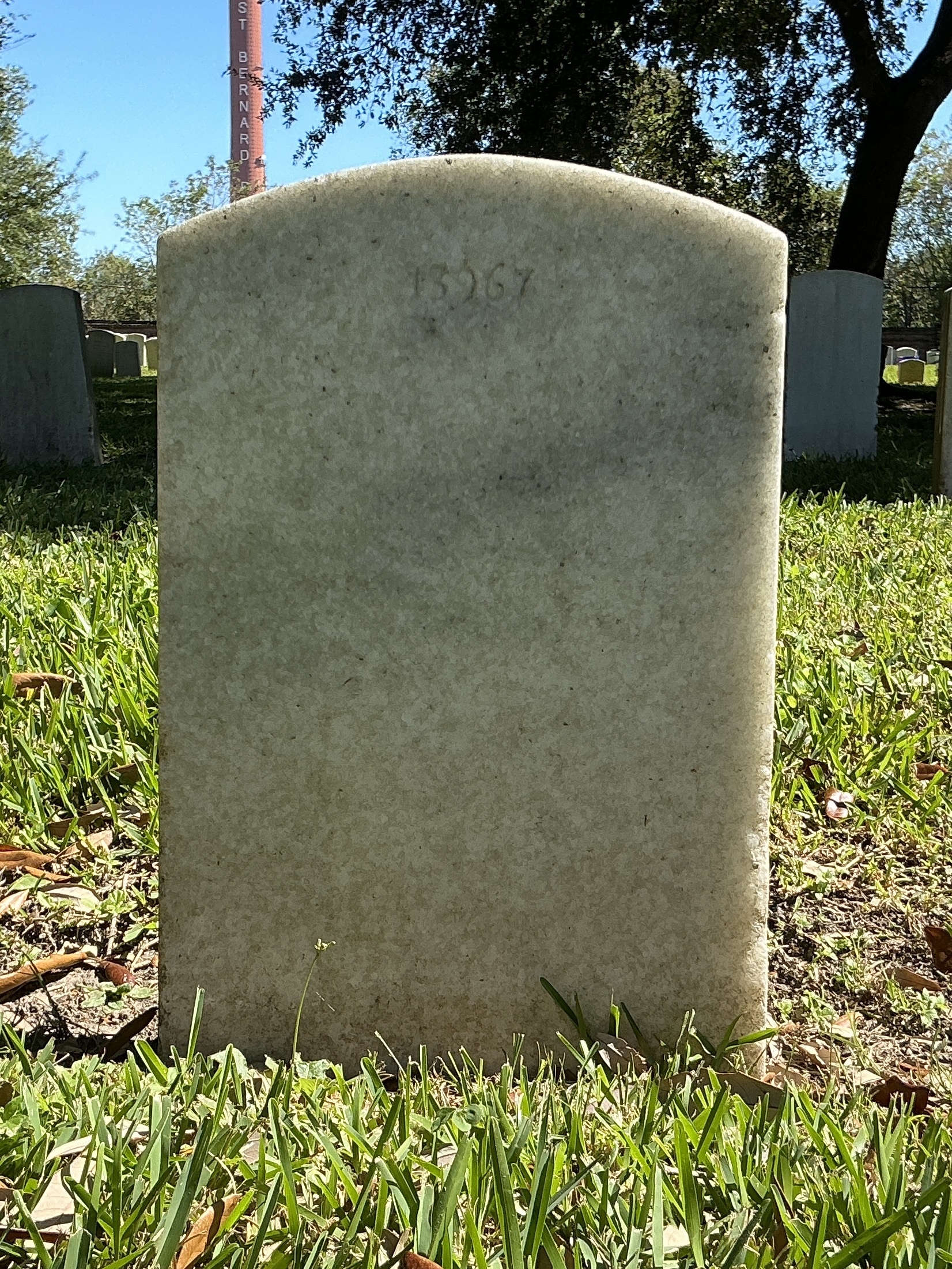 Back of upright marble headstone with flat face.