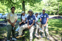 A group of five students smile at a camera. 