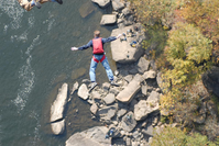 BASE jumper falling towards the river