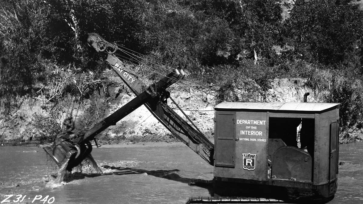 Power shovel cleaning out riverbed of Virgin River in Zion Canyon.