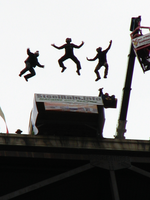 Three BASE jumpers leap from the bridge