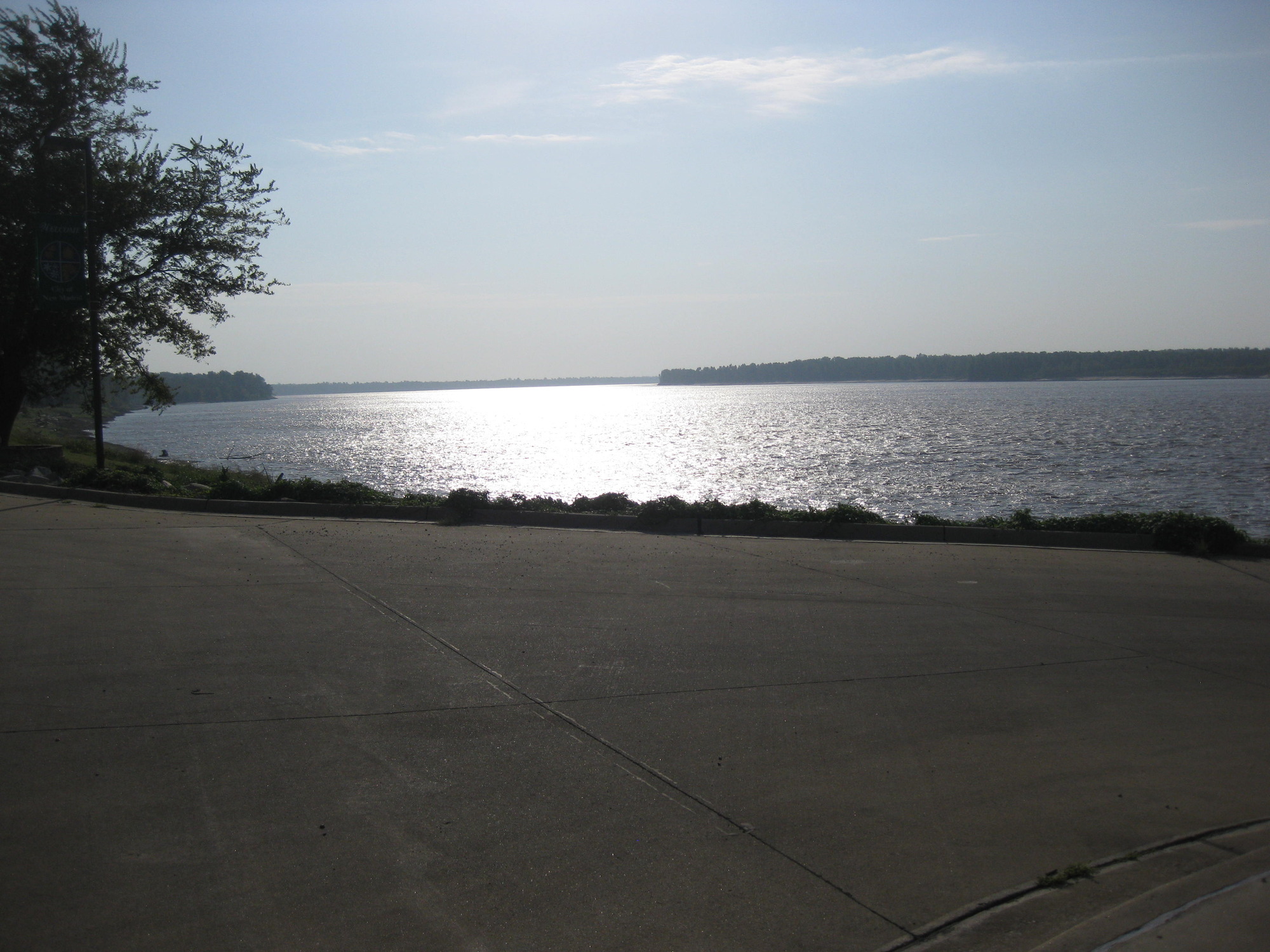 A concrete road near a body of water.
