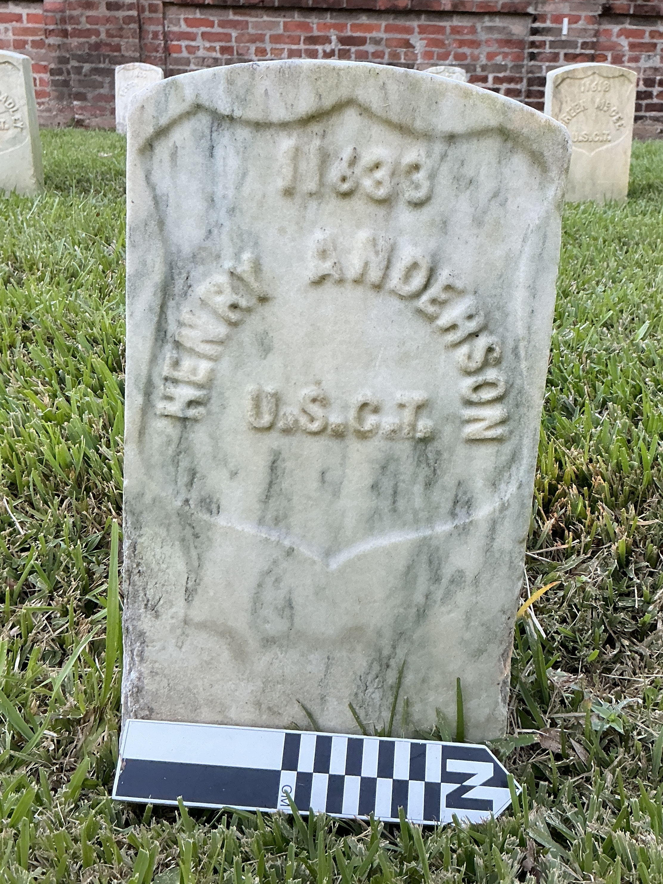 Extra image of historic upright marble headstone with recessed shield face.
