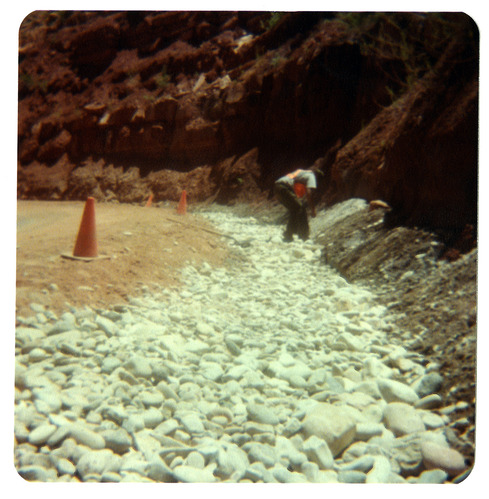 Man works with gravel along the Zion-Mt. Carmel Highway switchbacks.