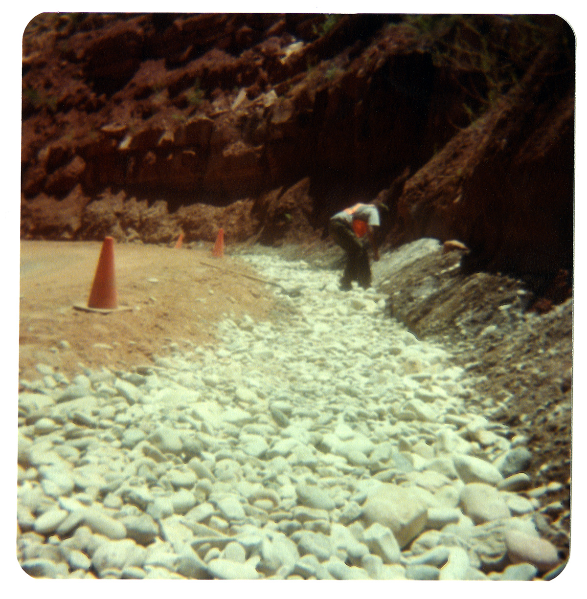 Man works with gravel along the Zion-Mt. Carmel Highway switchbacks.