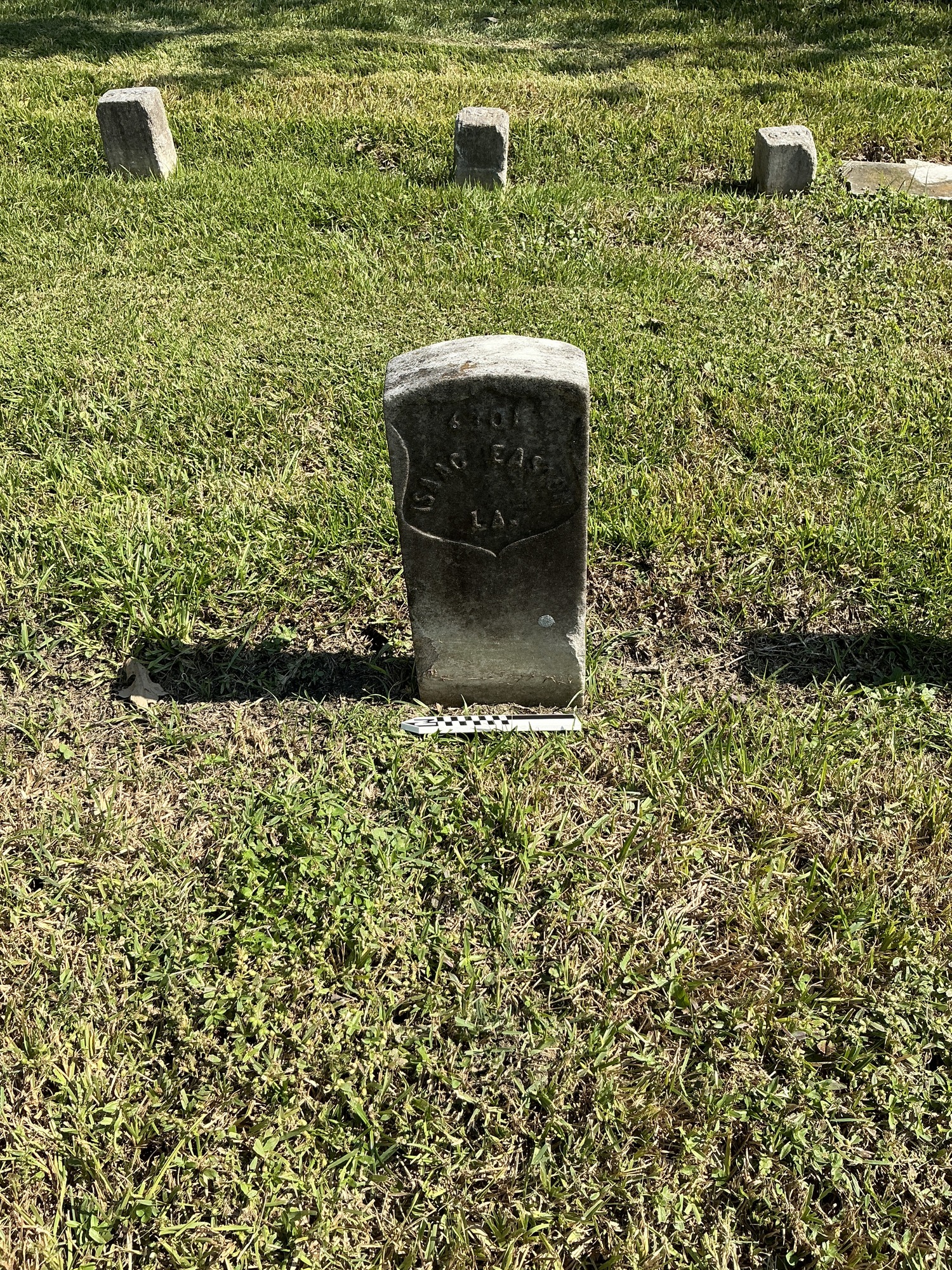 Extra image of historic upright marble headstone with recessed shield face.