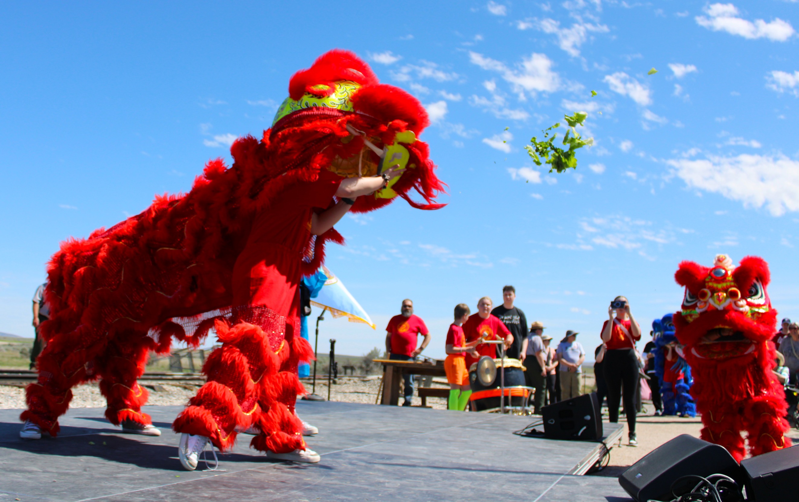 Chinese Orange, Red Lion costumes on stage.