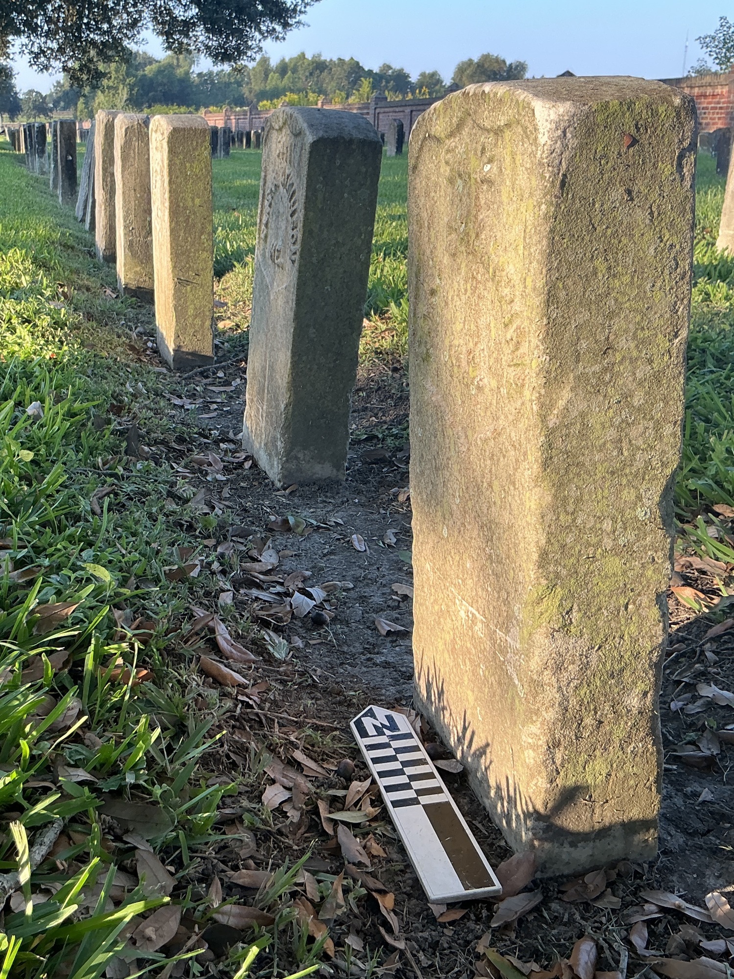 Extra image of historic upright marble headstone with recessed shield face.