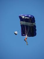 a BASE jumper against a blue sky