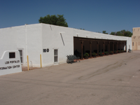 A white building close to a road.