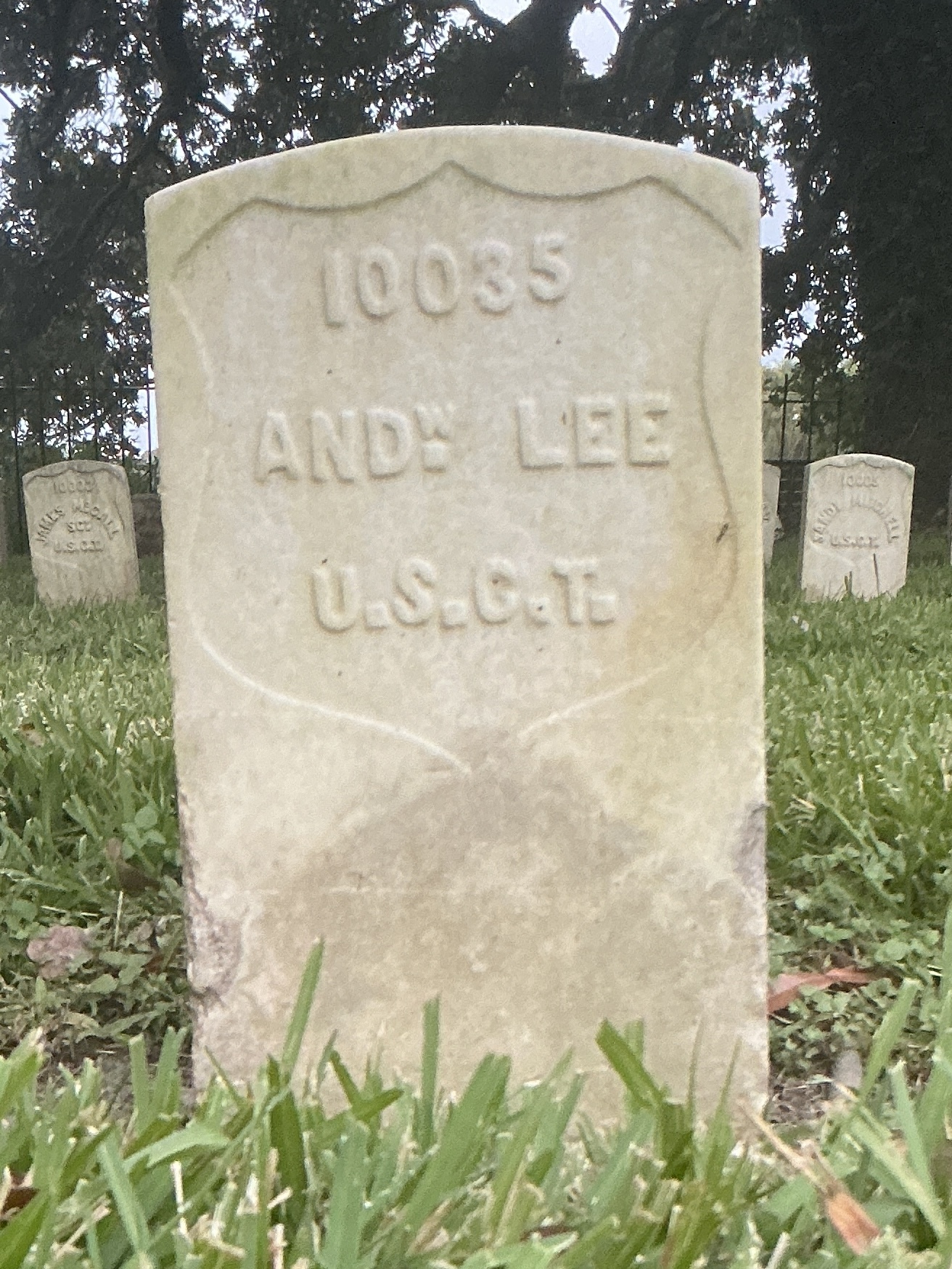 Front of historic upright marble headstone with recessed shield face.