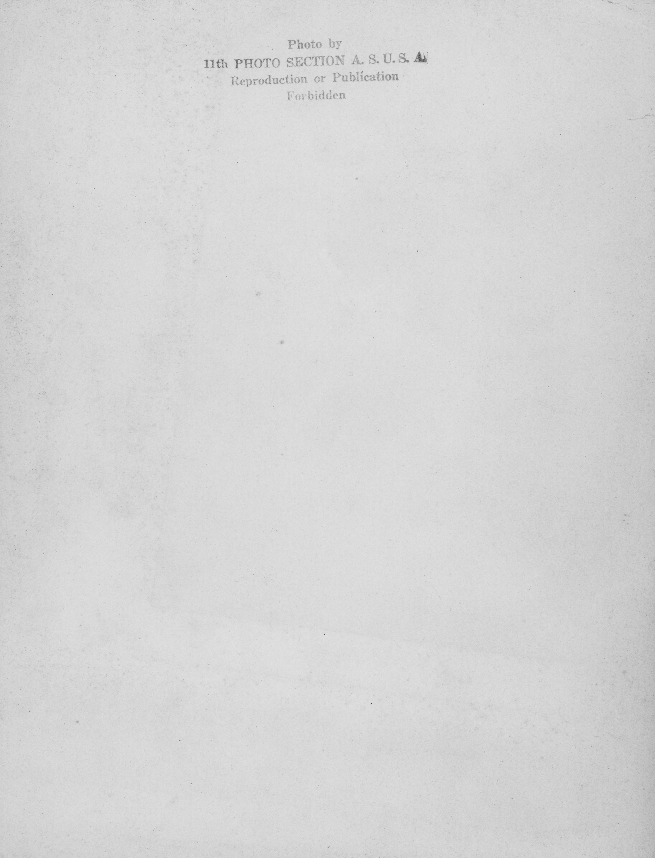 Reverse side of a photograph, stamped writing reads, "Photo by 11th Photo Section A. S. U.S.A. Reproduction or Publication Forbidden."