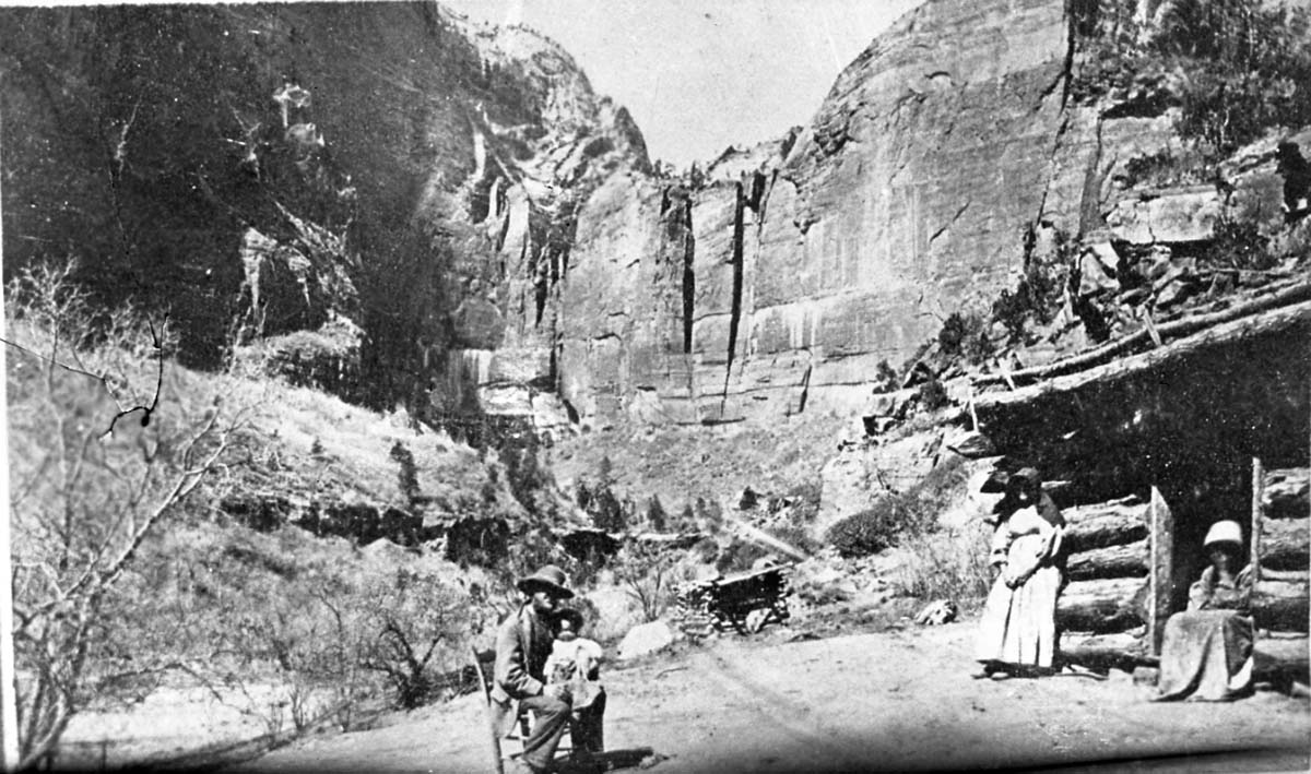 The Heaps family in front of their cabin in Zion Canyon, circa 1870. William Henry Harrison Heaps (born 1858) and Cynthia Jane Adams. Area called Heaps Canyon, now known as Emerald Pools.
