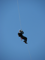 a rappeller dangles on a rope