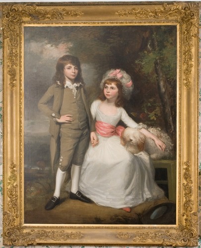 Double full-length portrait of a boy, standing, and girl, wearing white dress with pink sash and seated with arm over dog