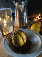 A pomander in a bowl of spices.