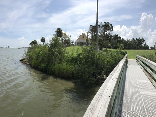 The image is taken on the dock looking west at the homes on top of the mound.