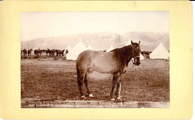 Comanche with tents in the background