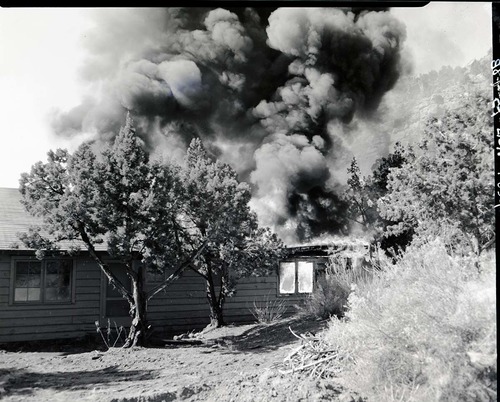 Demolition of Building 13 by fire - old headquarters building, later used for ranger residence and then girls' dormitory.