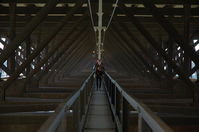 a rappeller walks along the catwalk under the bridge