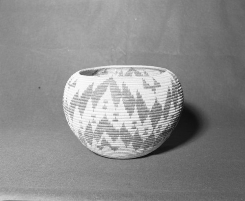 Mrs. Donald Segerstrom Collection. Object: Paiute basket. Dimensions: 13 x 9". Materials: willow, bracken fern, redbud. Technology: three rod foundation, interlocking stitch, fag ends trimmed on work face, moving ends trimmed on interior. Collection History: Made by Rosie Brown August in 1947 of Bridgeport, California. Gift of Ella Cain. Attached exhibit tag from Mono County (?) fair. Photographed by Michael Dixon, January 1983. Catalogued by Craig Bates and Barbara Beroza. Yosemite Collections, National Park Service.