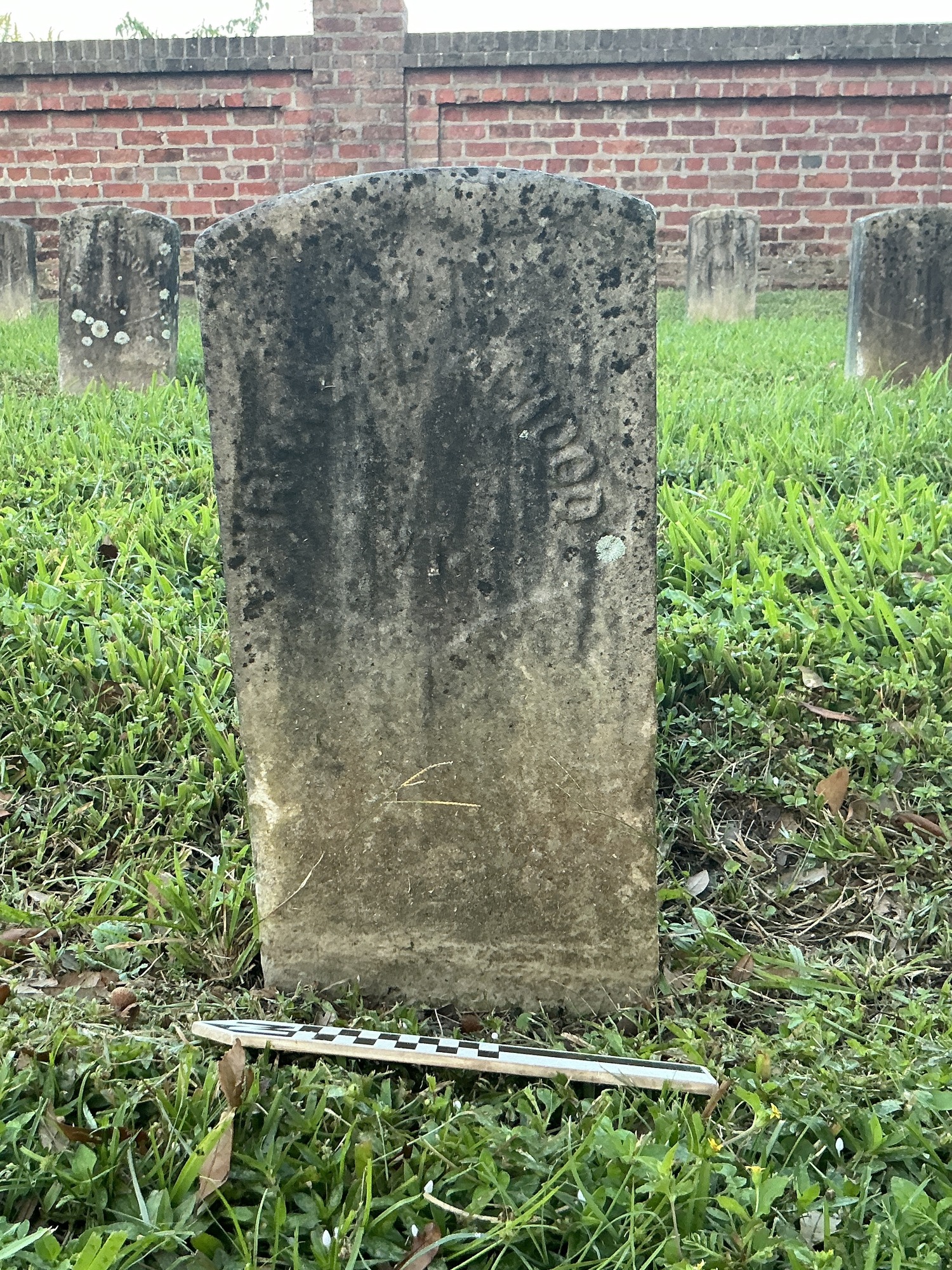 Extra image of historic upright marble headstone with recessed shield face.