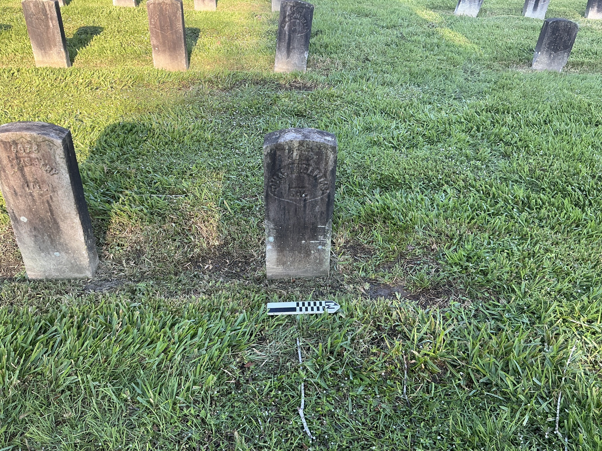 Extra image of historic upright marble headstone with recessed shield with recessed lettering face.