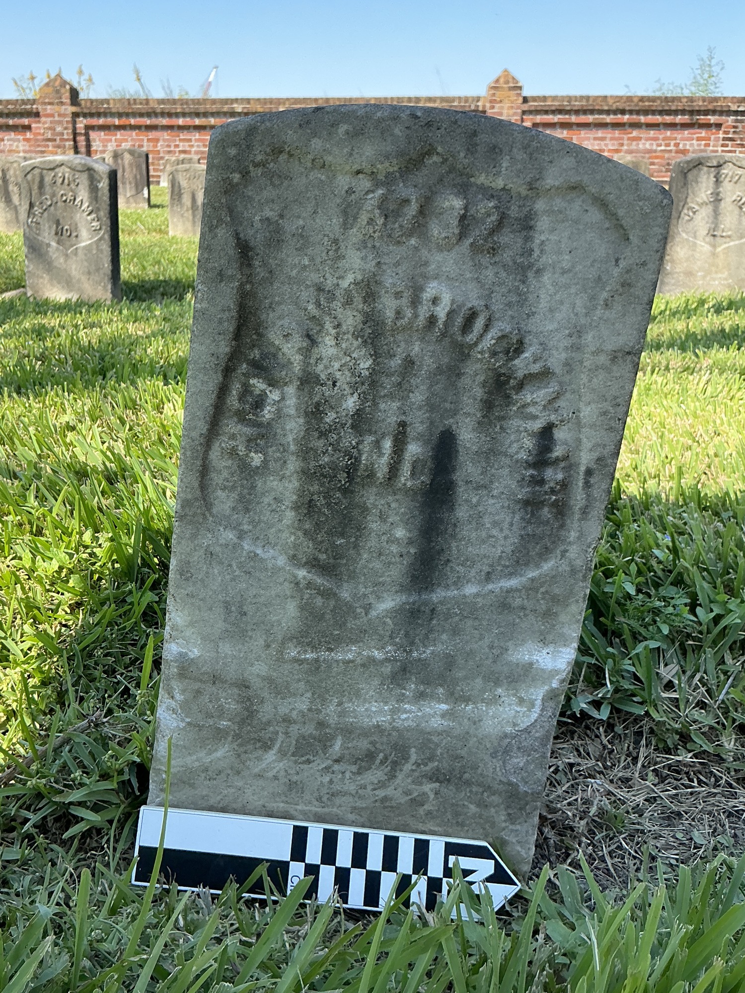 Extra image of historic upright marble headstone with recessed shield face.