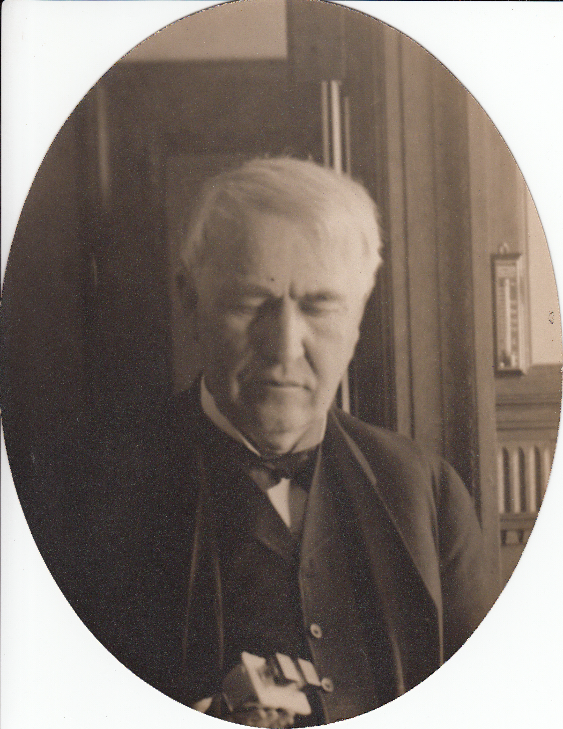 Thomas Edison holding an unidentified instrument.