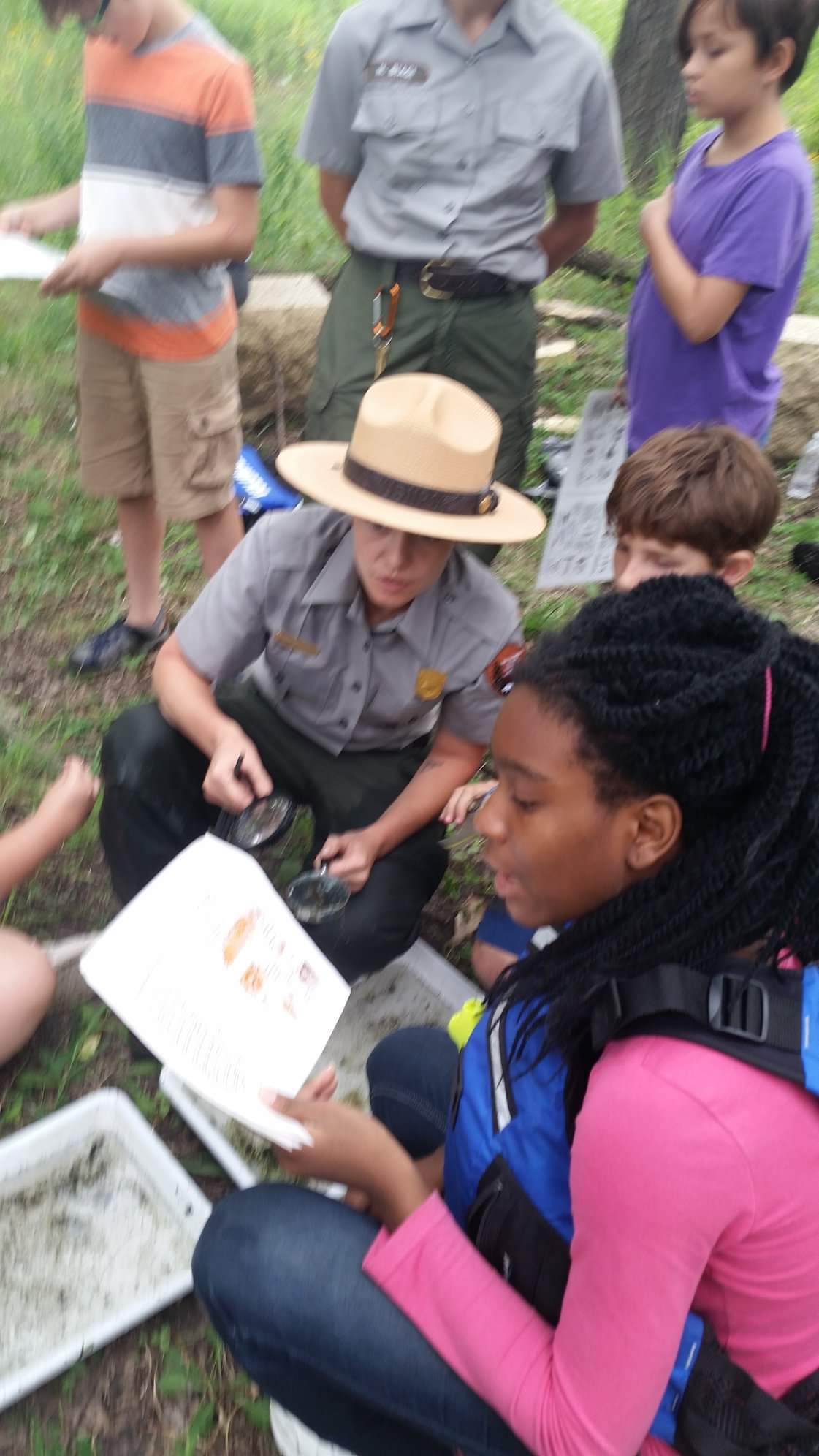 A park ranger teaching students on a field trip. 